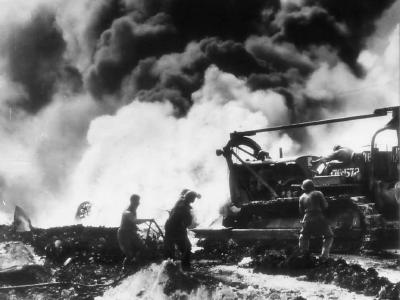 Aviation Engineers man bulldozer bybAviation Engineers man bulldozer by burning B-29 on Saipan December 1944urning B-29 on Saipan dec44