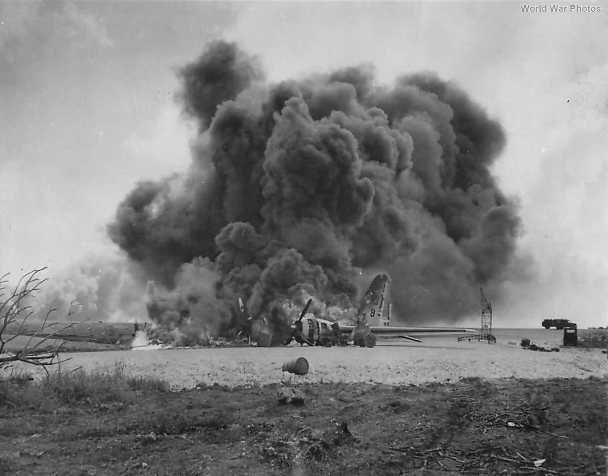 Burning B-29 of 73rd BW following Japanese attack on Isley Field 1944
