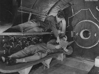 Crewmembers relax on bunks in crew compartment of B-29