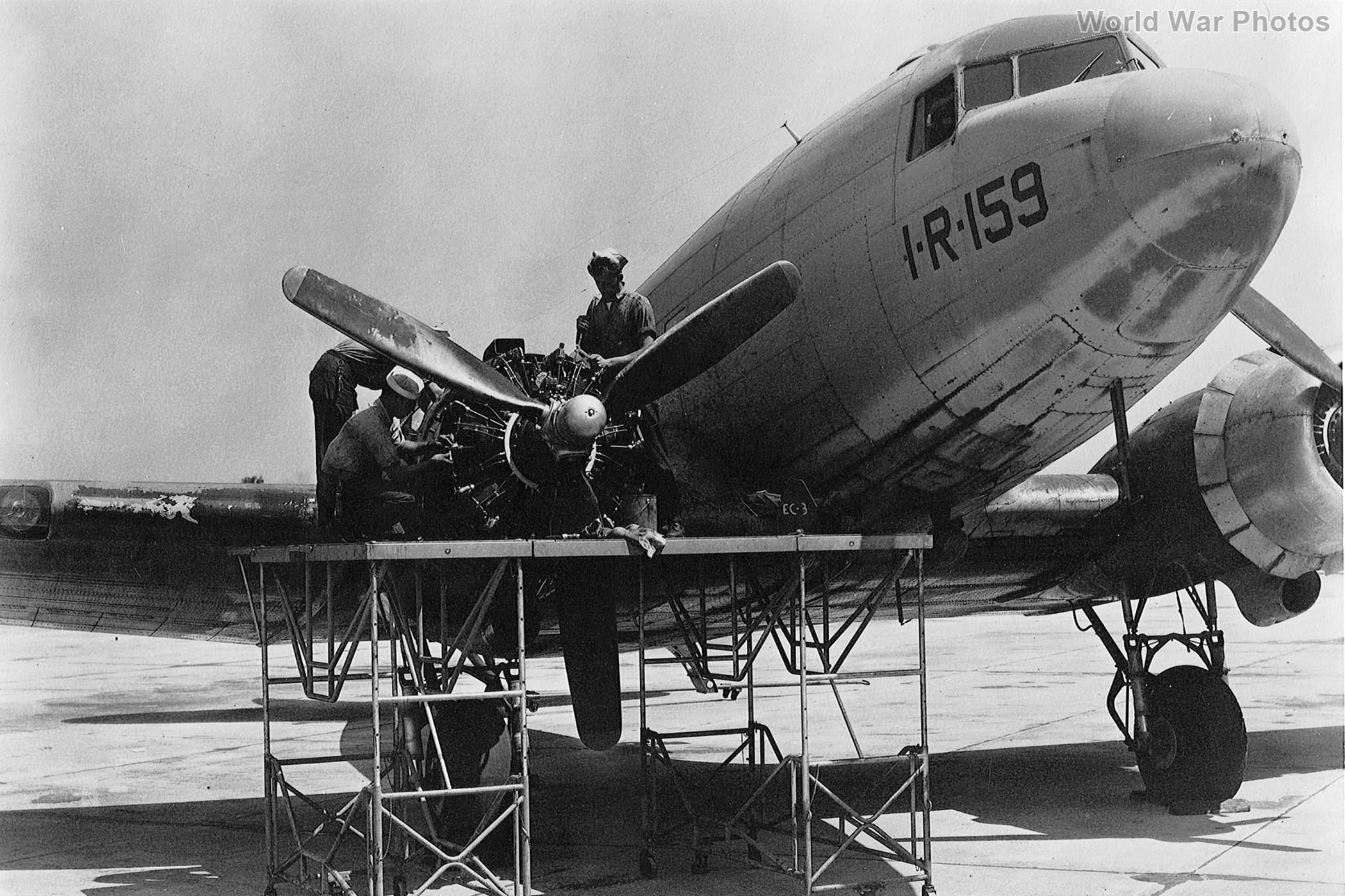 Sailors at work on the engine of an R4D