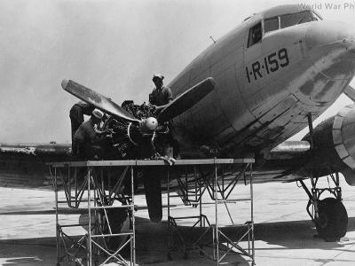 Sailors at work on the engine of an R4D