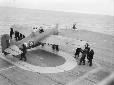 Grumman Wildcat fighter of No 882 Squadron Fleet Air Arm being manoeuvred into position for takeoff from HMS PURSUER off the northern coast of Norway