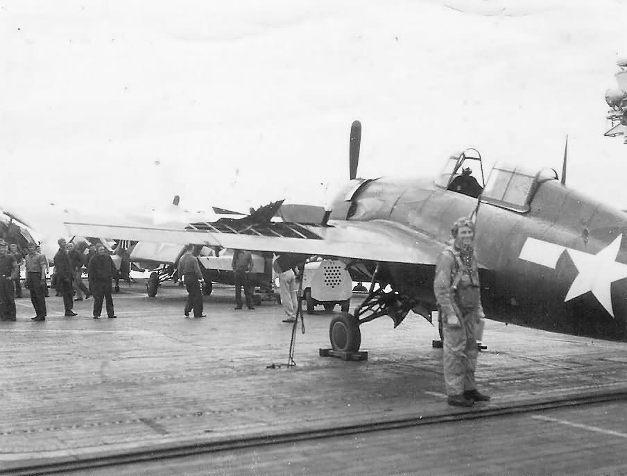 Pilot by His damaged F4F Wildcat on Aircraft Carrier Deck