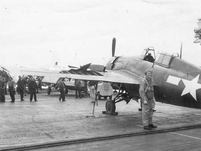 Pilot by His damaged F4F Wildcat on Aircraft Carrier Deck