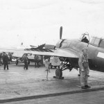 Pilot by His damaged F4F Wildcat on Aircraft Carrier Deck