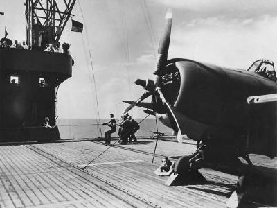 Crew starts F4F using boot and shock cord aboard USS Charger