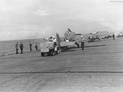 Hebard A14 tug hauls F4F of the VF-9 into position on carrier 42