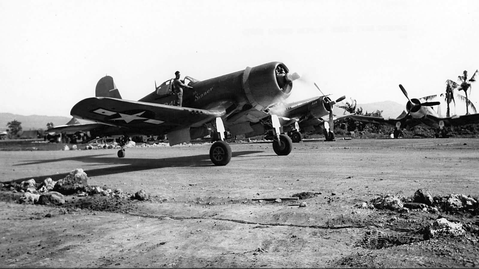F4U Corsair of the MAG 21 Guam mechanic on the wing guiding the pilot October 12, 1944