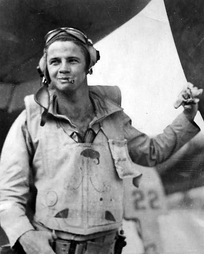 Marine fighter pilot Lt. David Riley by his F4U Corsair 22 1944
