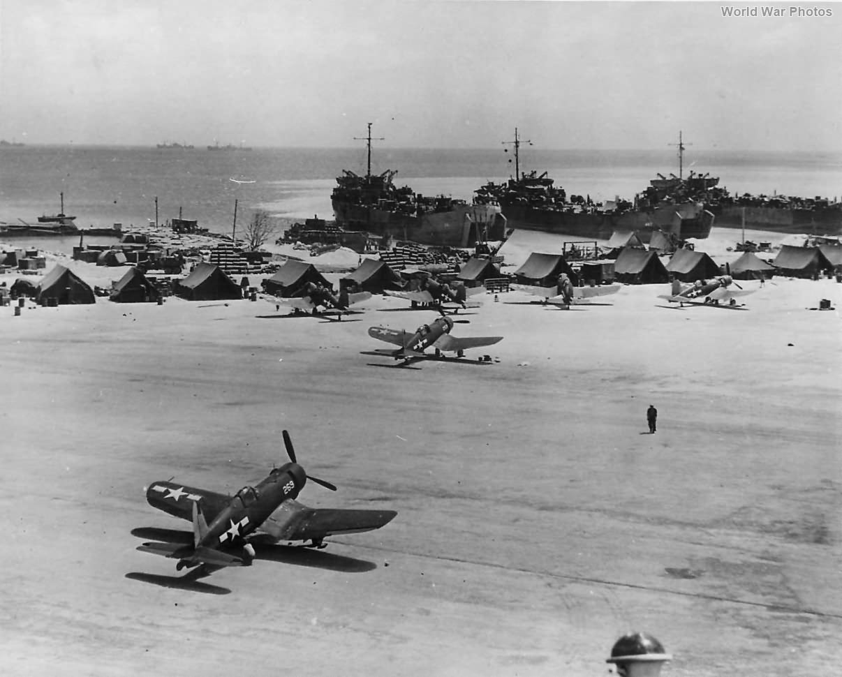 Corsairs on runway and LSTs on Beach at a Marshall Islands Base 1944