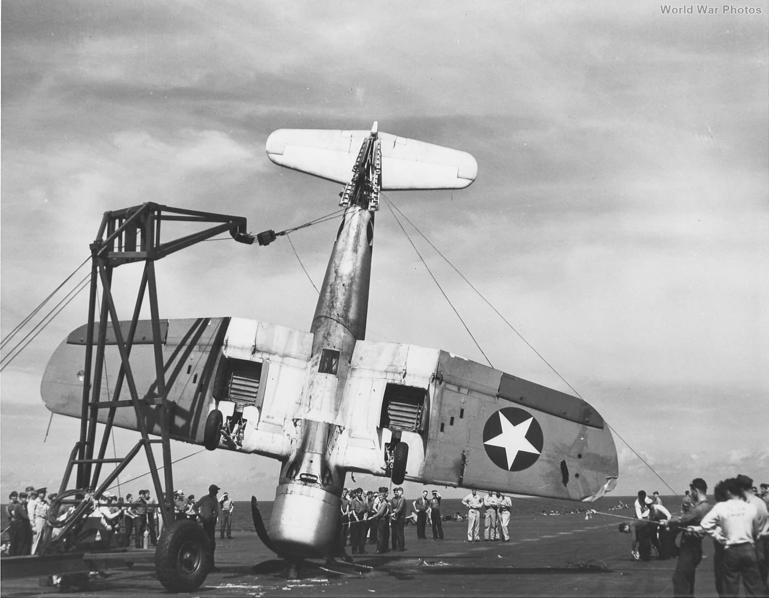 F4U-1 of VF-17 is being lifted from the deck of USS Bunker Hill