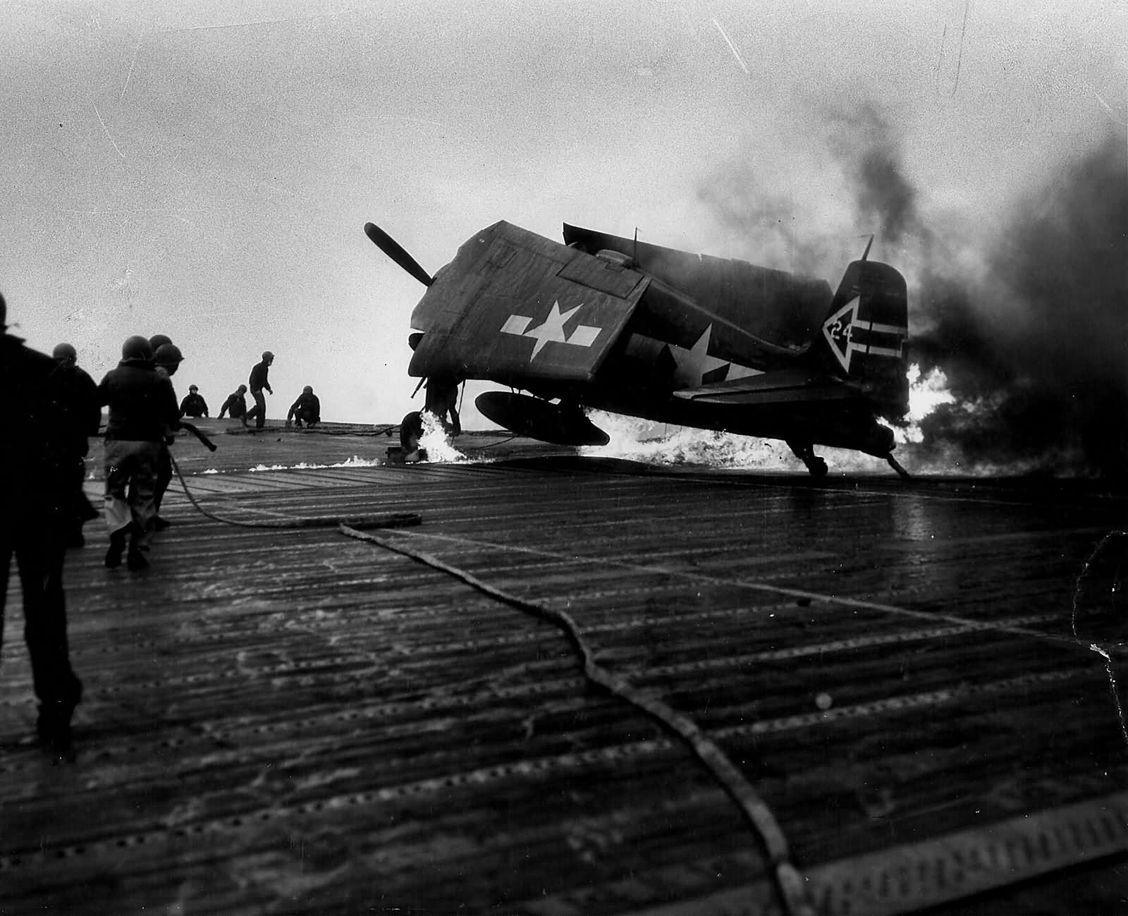 F6F-5N Hellcat #24 of VF(N)-90 burns on the flight deck of the carrier USS Enterprise CV-6 – April 1945 Okinawa