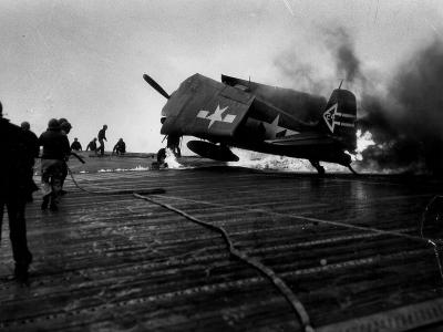 F6F-5N Hellcat #24 of VF(N)-90 burns on the flight deck of the carrier USS Enterprise CV-6 – April 1945 Okinawa