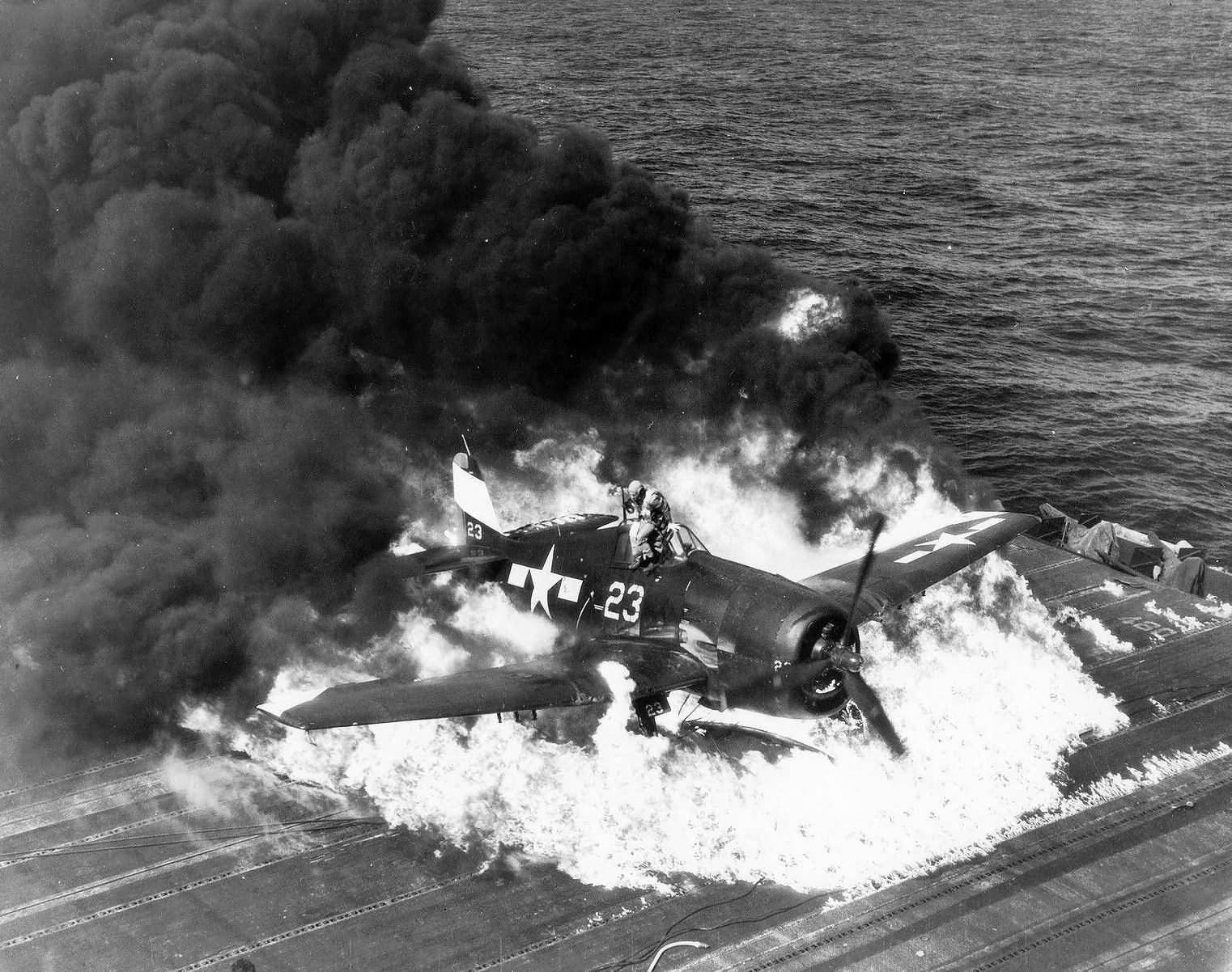 Pilot escaping from burning F6F-5 Hellcat code white 23 of VF-9 USS Lexington. Pilot Ens. Ardon R. Ives, 25 February 1945