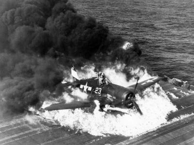 Pilot escaping from burning F6F-5 Hellcat code white 23 of VF-9 USS Lexington. Pilot Ens. Ardon R. Ives, 25 February 1945