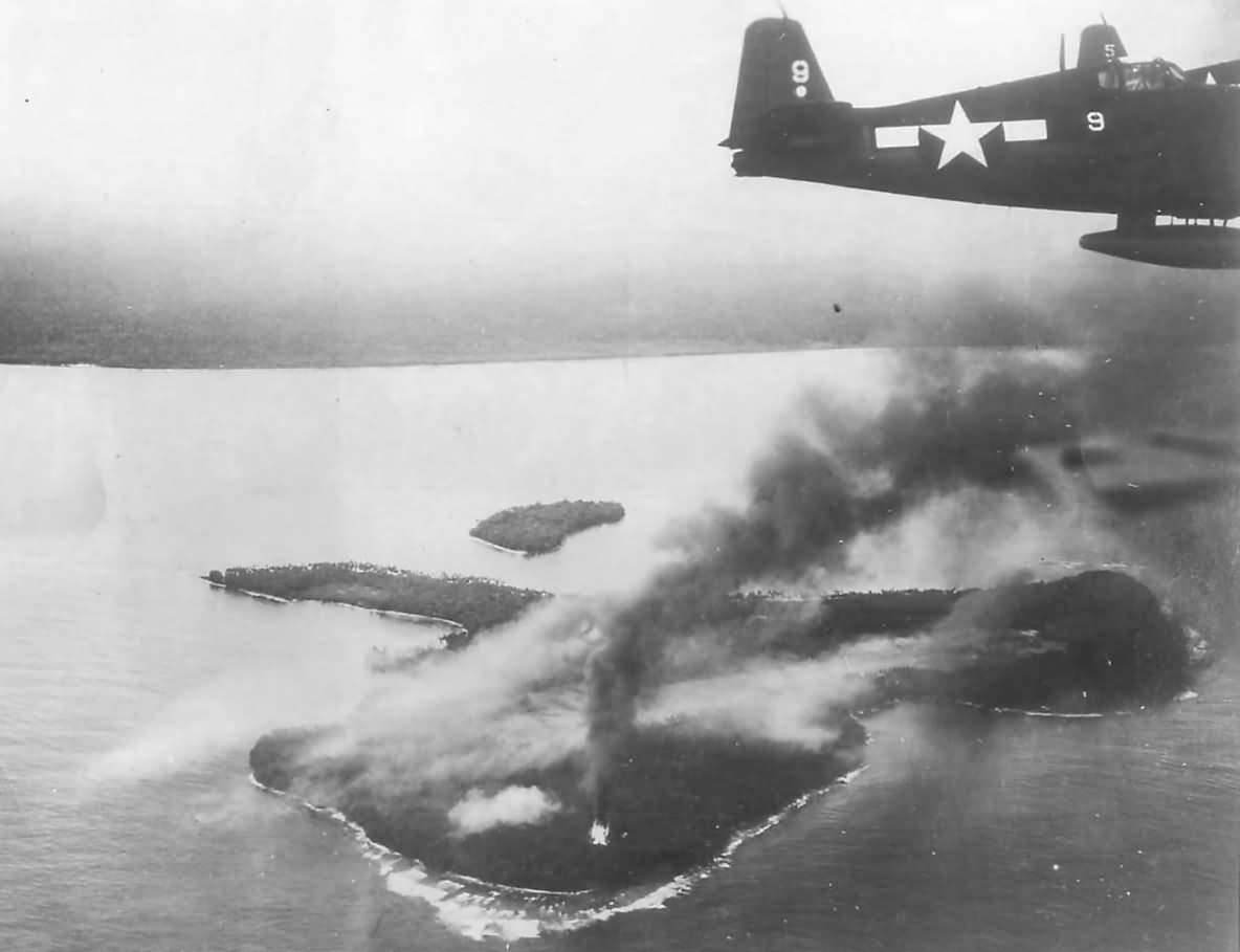 F6F Hellcat #9 flying over burning Wakde Island USS Hornet 1944