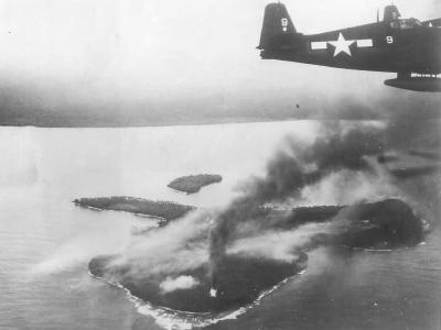 F6F Hellcat #9 flying over burning Wakde Island USS Hornet 1944