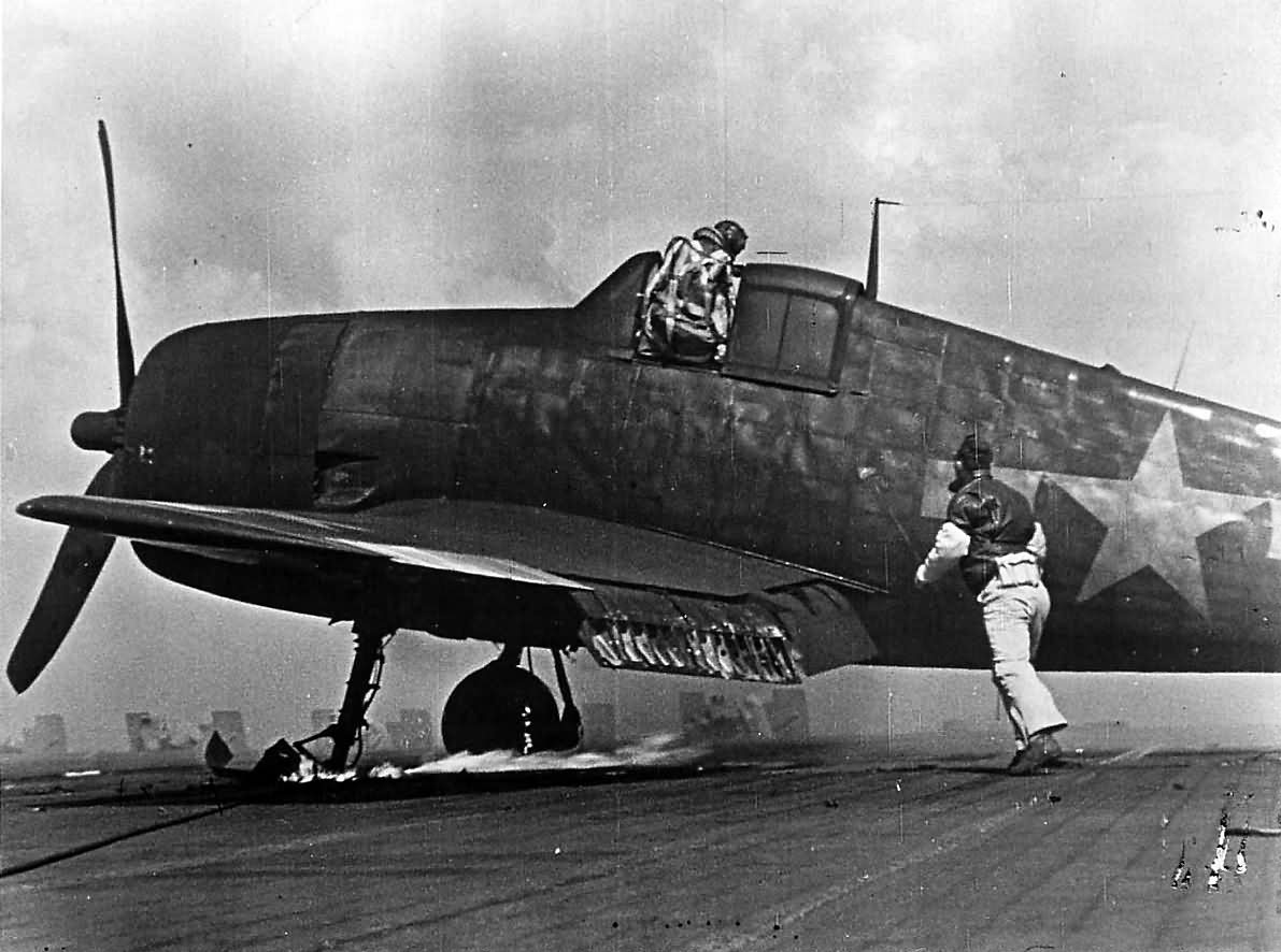 F6F pilot exits cockpit after Kamikaze attack on carrier 1945