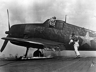 F6F pilot exits cockpit after Kamikaze attack on carrier 1945