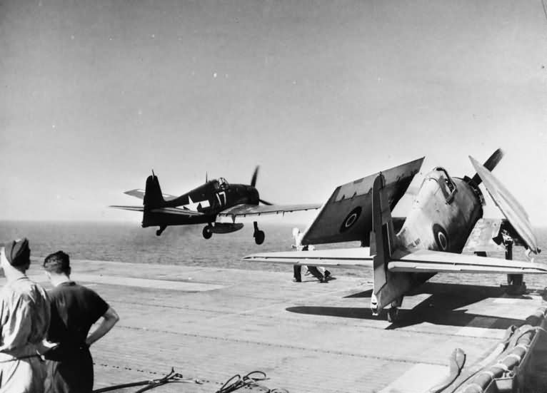 US F6F Hellcat fighter flying off the deck of HMS Empero and Grumman Hellcat of 800 Squadron