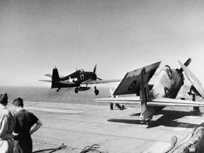 US F6F Hellcat fighter flying off the deck of HMS Empero and Grumman Hellcat of 800 Squadron