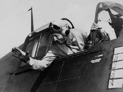 Lt Cdr Edward Outlaw waves from the cockpit of his F6F-3 Hellcat