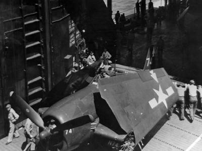 USS Bennington CV-20 crew push F6F-5 #74 of VF-82 – February 1945