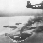 F6F Hellcat #9 flying over burning Wakde Island USS Hornet 1944