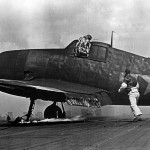 F6F pilot exits cockpit after Kamikaze attack on carrier 1945