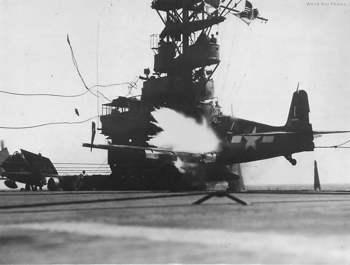 F6F of VF-33 explodes as wing hits Island of USS Sangamon