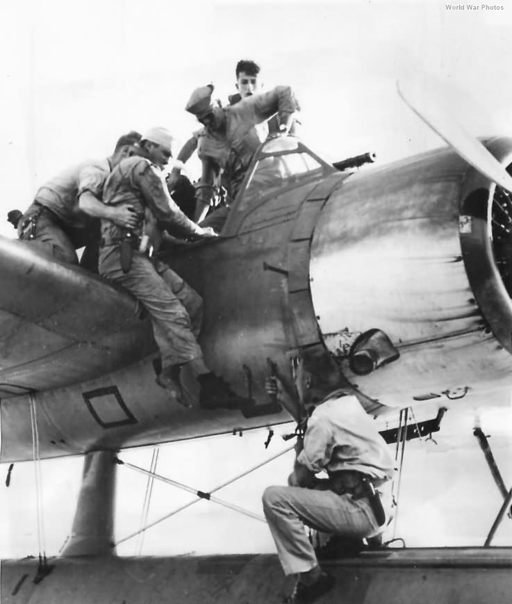 Wounded Airman helped from OS2U after rescue from Pacific 44