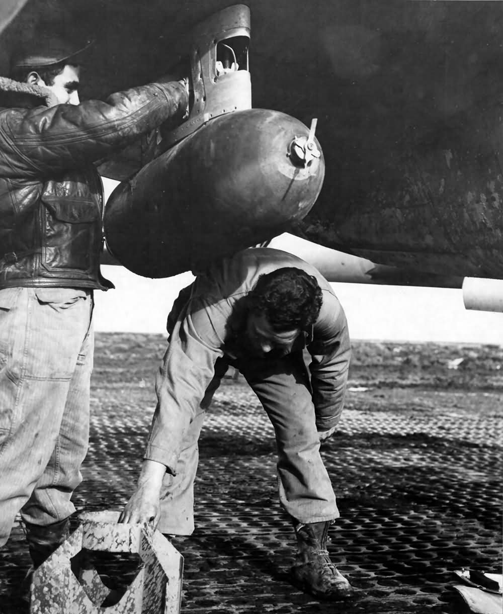 A 500 lb Bomb Is Attached Under the Wing Of A P-38 Lightning By Members Of the 94th Fighter Squadron 1st FG Italy