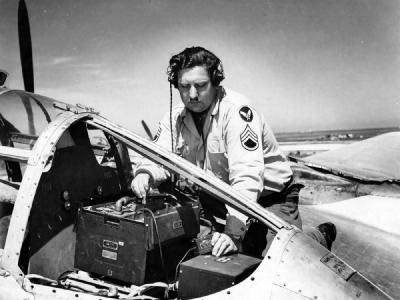 A Member Of the 94th Fighter Squadron 1st Fighter Group Checks Radio Equipment In A P-38 Lightning Italy