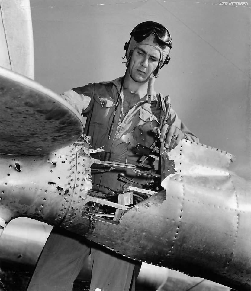 1st Lt Robert H. Amon from 318th FG inspecting damaged tail boom of his P-38