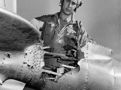 1st Lt Robert H. Amon from 318th FG inspecting damaged tail boom of his P-38