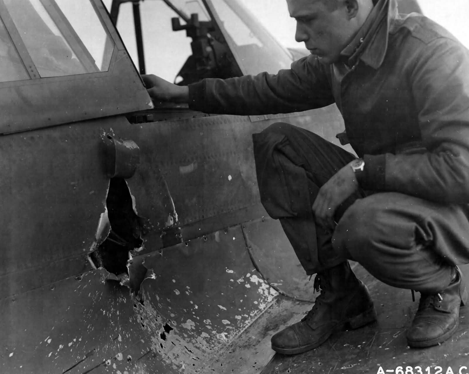 79th Fighter Group Based At Capodichino Italy pilot Examines his Damaged P-40
