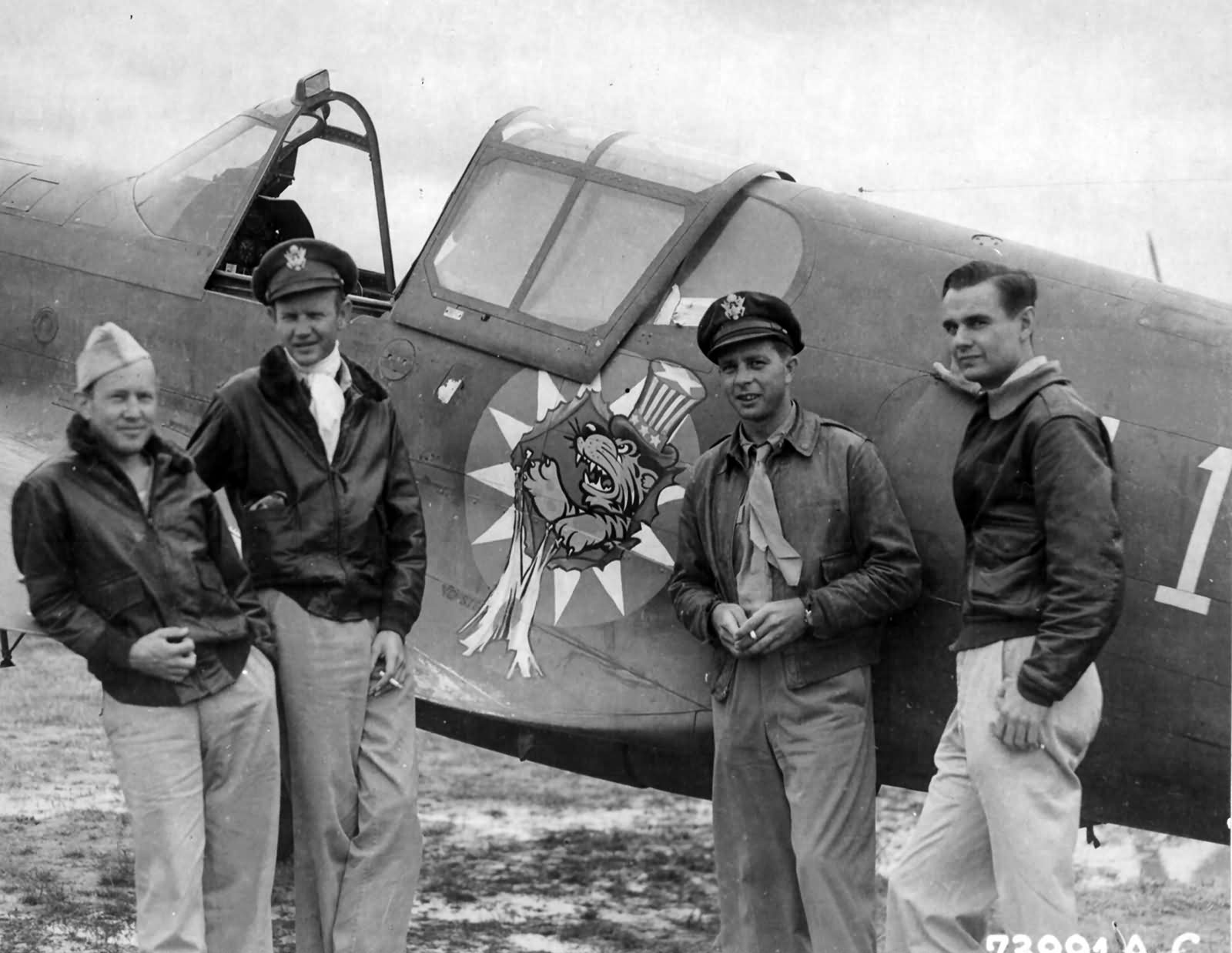 Former Members Of The AVG Serving With The 23rd Fighter Group Stand Beside A Curtiss P-40 With The Insignia Of The Group