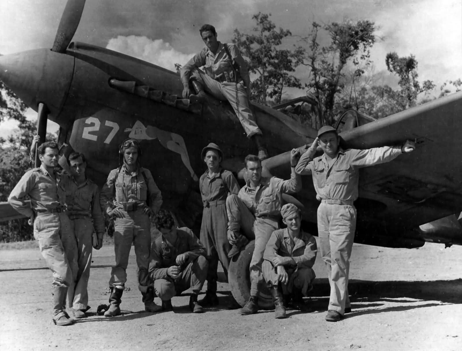 Members of the 49th Fighter Group pose beside a Curtiss P-40