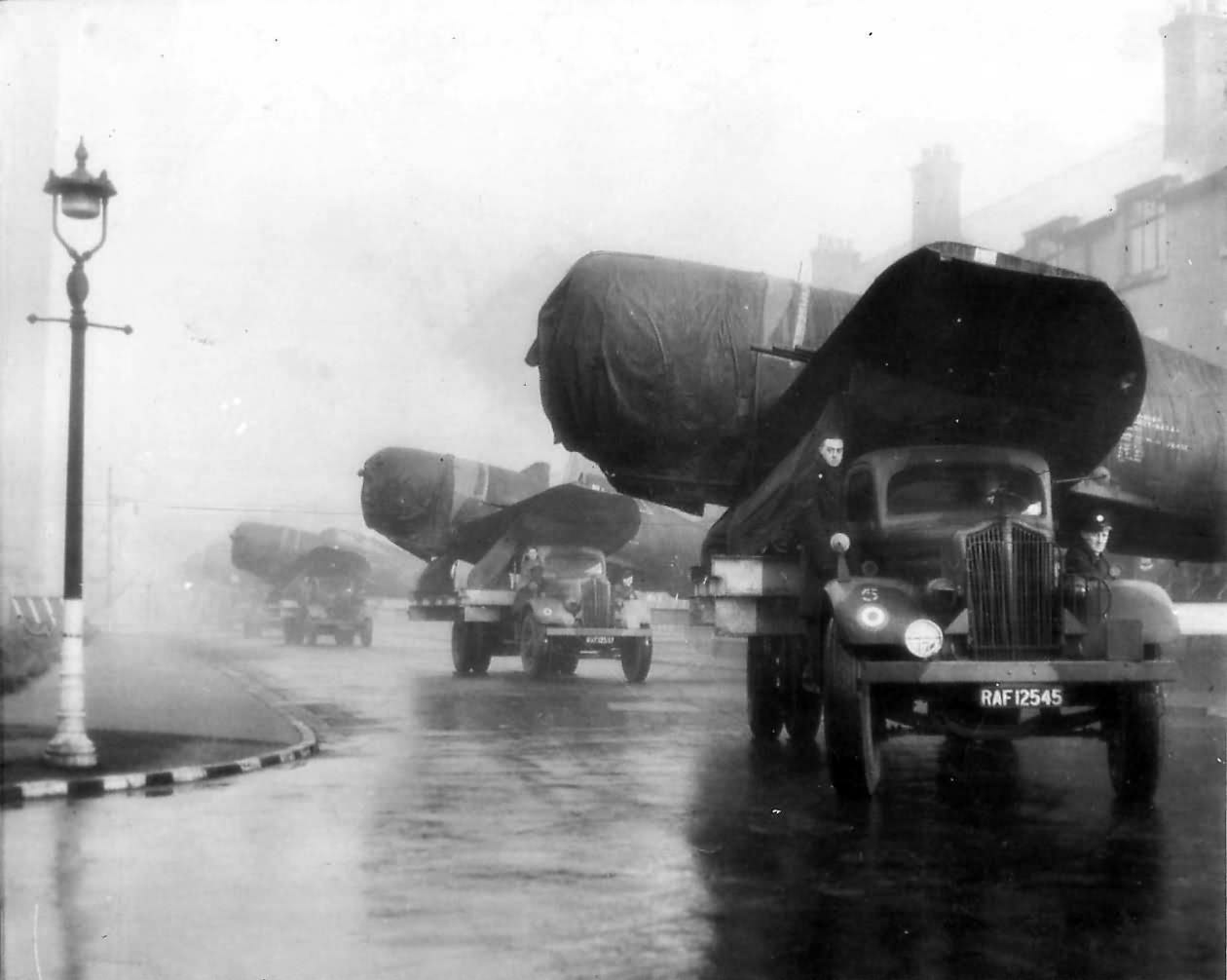 Convoy of P-47 Thunderbolts Pass thru English Town Enroute to Depot 1944