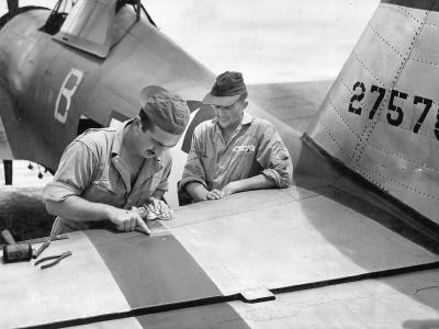 Ground Crew of the 318th FG repairing damage on P-47D
