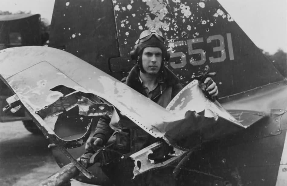Lt Casteel of the 63rd FS, 56th FG stands beside his battle damaged P-47 UN-A 43-25531 – May 1944