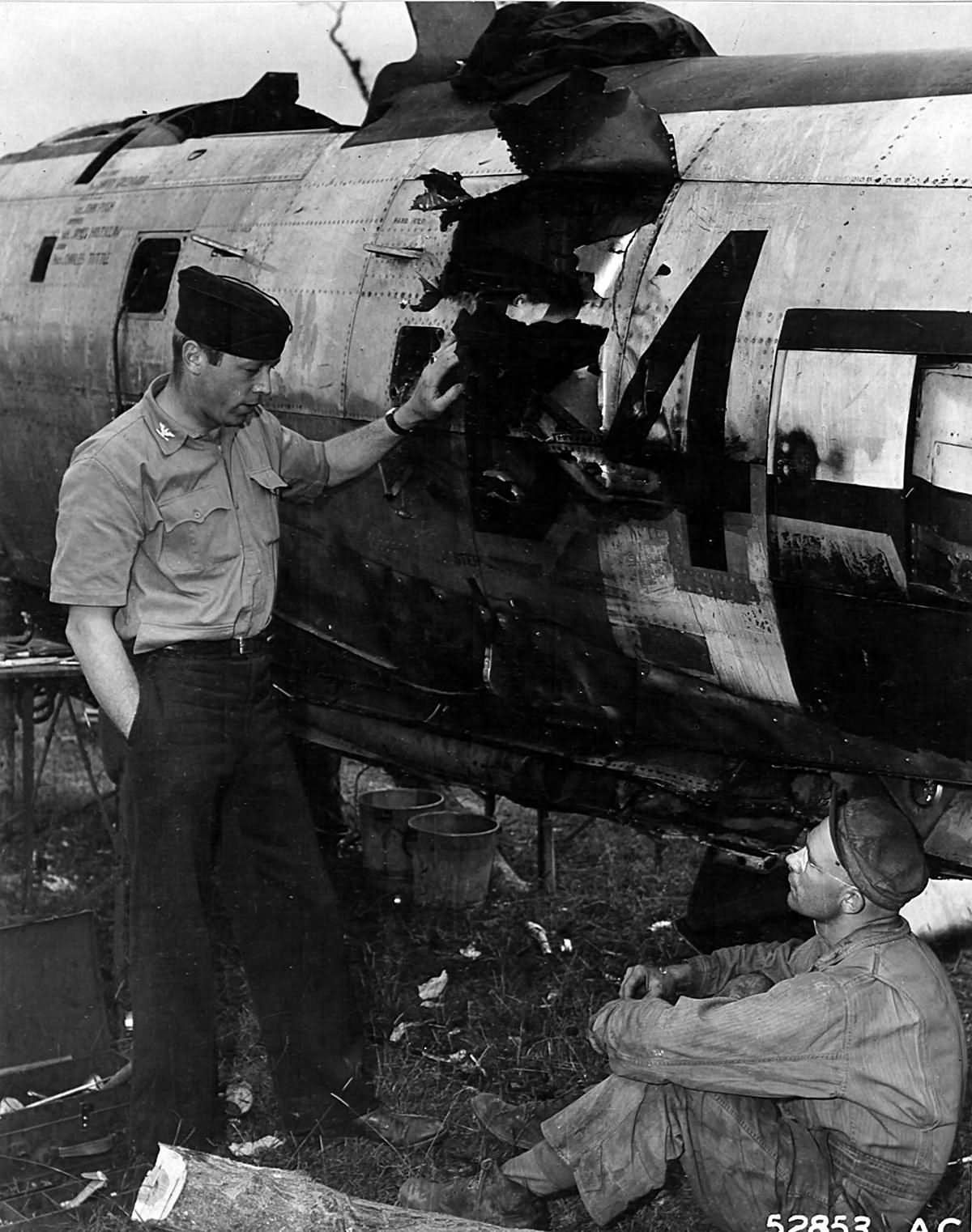 Col Stecker 365th FG inspects a flak hole in his P-47 Thunderbolt Azeville airfield A-7 France 1944