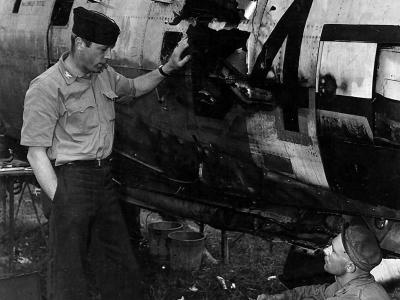 Col Stecker 365th FG inspects a flak hole in his P-47 Thunderbolt Azeville airfield A-7 France 1944