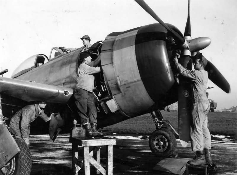 Ground crew carry out checks and maintenance work on P-47D-30-RE Thunderbolt, code HV-X 44-20626