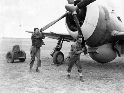 Ground crew of the 78th Fighter Group manually start the engine of a P-47 1943