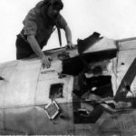 Col Ray J. Stecker of the 365th Fighter Group inspects a flak hole in his P-47 Azeville (A-7) France 1944