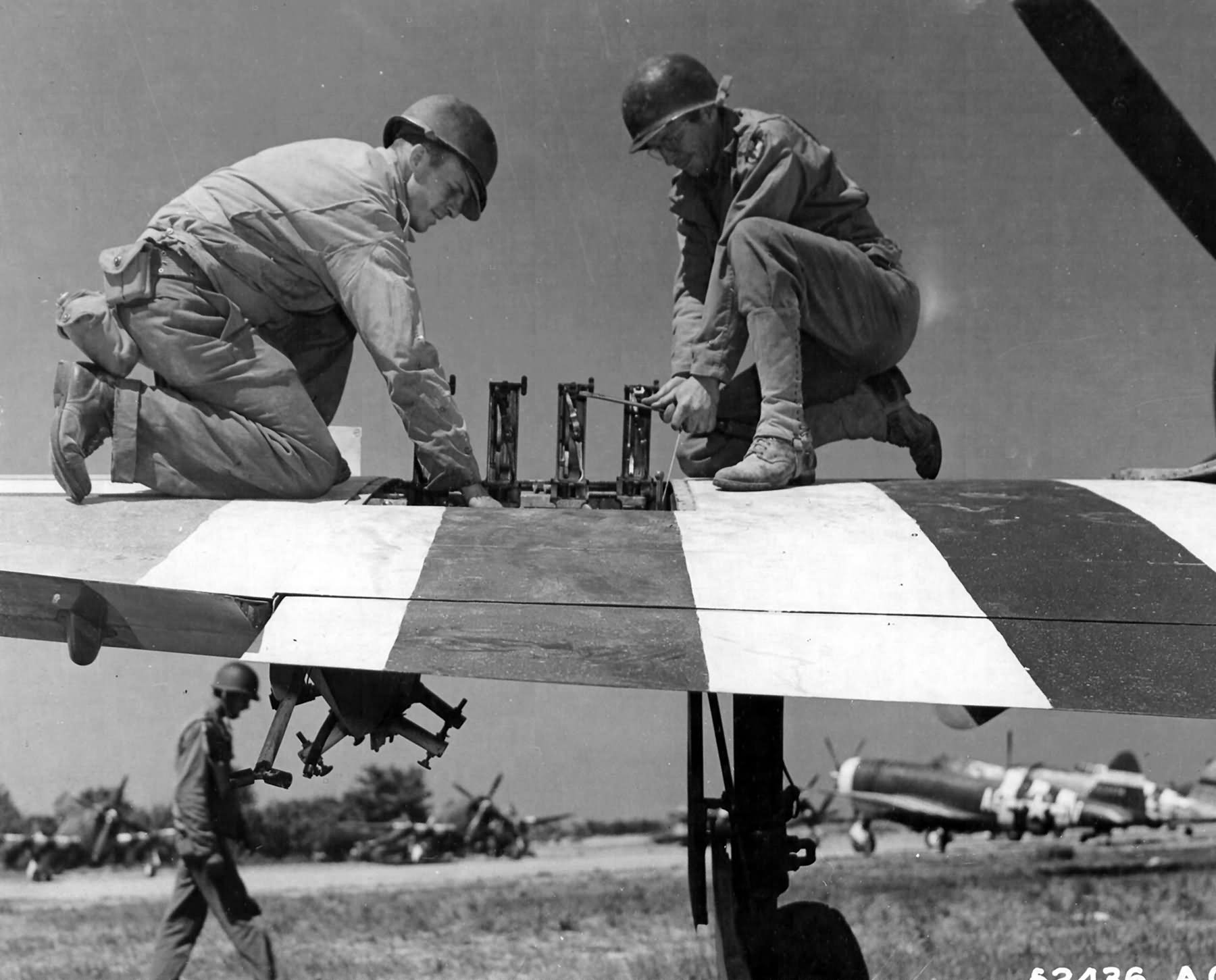 Armorers of the 366th FG service the weapons on a P-47 Thunderbolt at St Pierre du Mont airfield A-1, June 1944
