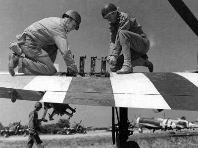 Armorers of the 366th FG service the weapons on a P-47 Thunderbolt at St Pierre du Mont airfield A-1, June 1944