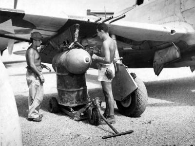 Loading 1000lb bomb on a P-47 of the 201st Mexican FS Porac Airstrip Philippine Islands – 26 June 1945