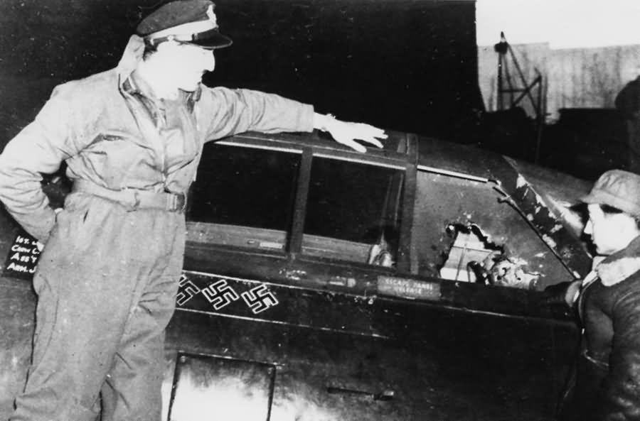 Pilot of the 78th Fighter Group inspects the damaged cockpit of a P-47 Thunderbolt